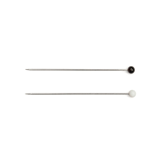 Two metal needles with black and white ends on a white background