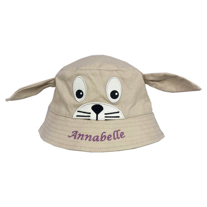 Beige bucket hat with dog face design and 'Annabelle' text on a white background