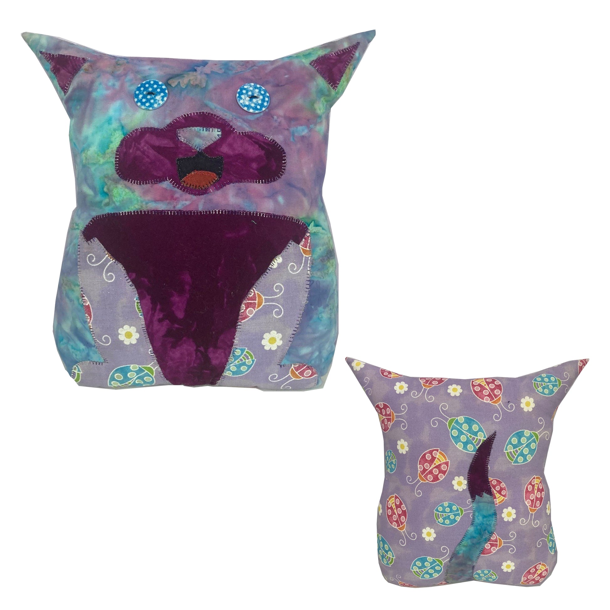 Handmade decorative pillows with colorful patterns on a white background