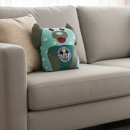 Plush toy with a design featuring Mickey Mouse and floral patterns on a light blue background.