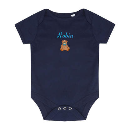 A navy blue short-sleeve baby bodysuit with three silver snap closures at the crotch. The chest features a personalized design with the name 'Robin' in light blue script above a small brown teddy bear wearing a blue bow tie.