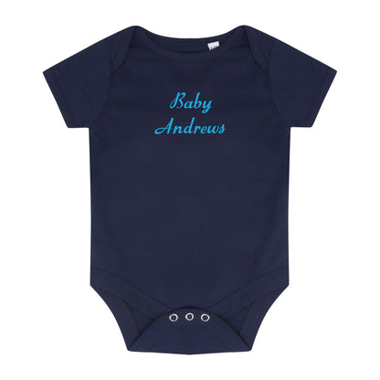 A navy blue short-sleeve baby bodysuit with 'Baby Andrews' embroidered in light blue cursive text across the chest, displayed on a solid white background.