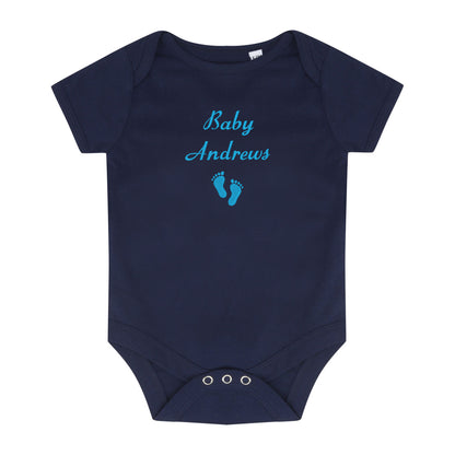 A navy blue short-sleeve baby bodysuit with 'Baby Andrews' and a pair of baby feet embroidered in light blue on the chest, displayed flat against a white background.