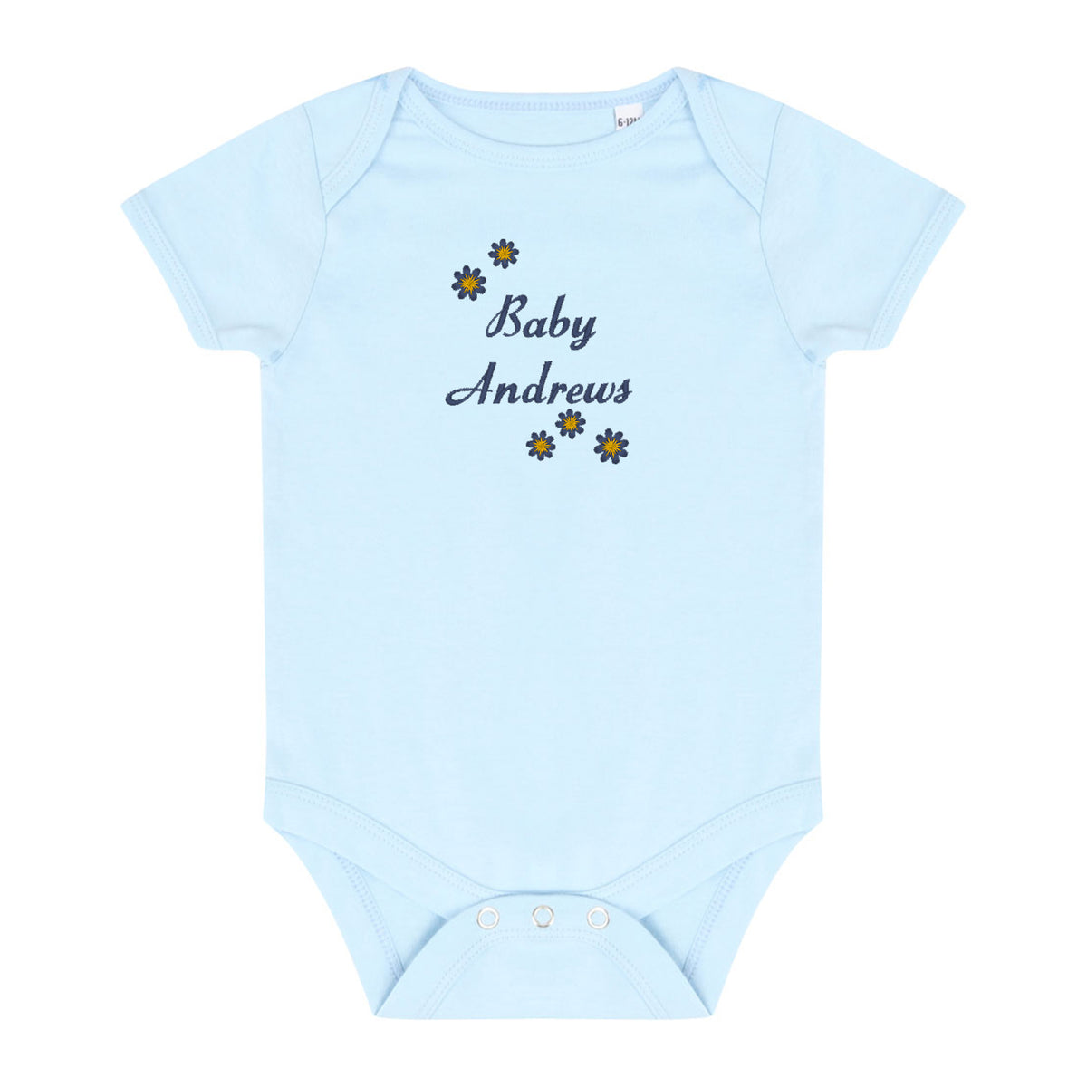 A light blue short-sleeve baby bodysuit with 'Baby Andrews' embroidered in navy script on the chest, surrounded by small yellow and navy flower motifs. The bodysuit has three white snap buttons at the crotch and is displayed flat against a solid white background.