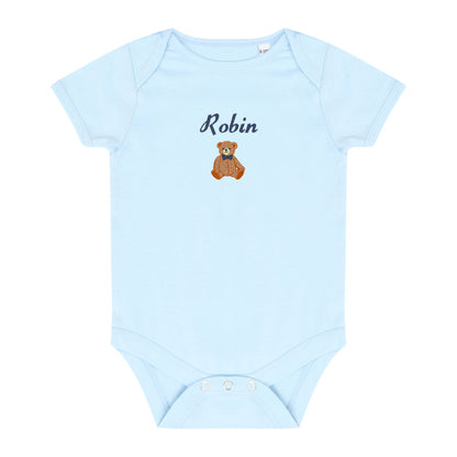 A light blue short-sleeve baby bodysuit with 'Robin' and a small brown teddy bear graphic embroidered on the chest, displayed flat against a white background.