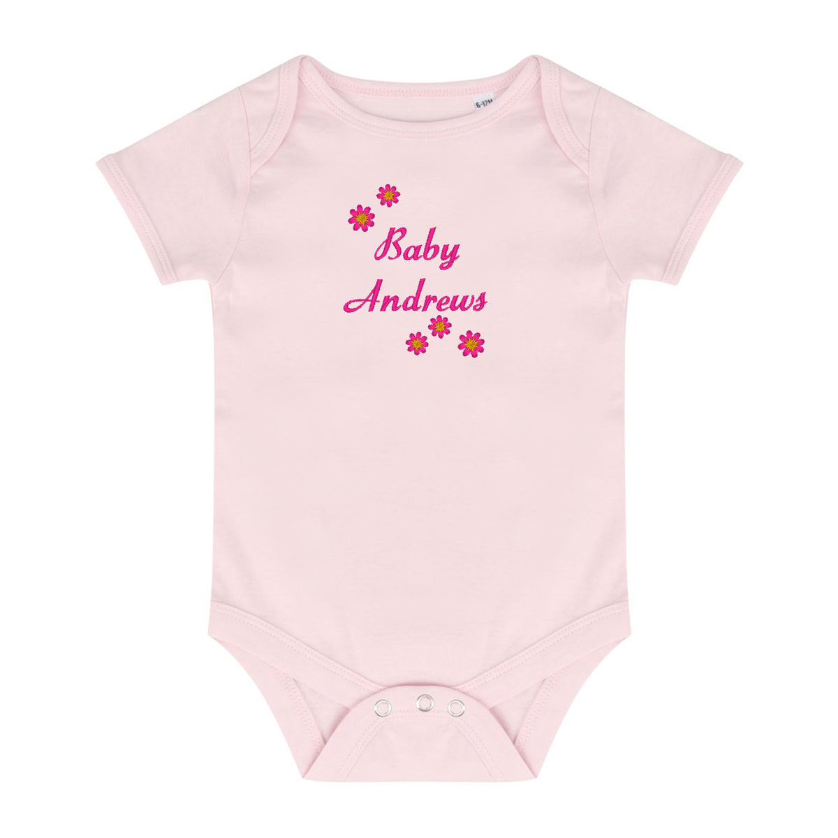 A light pink short-sleeve baby bodysuit with 'Baby Andrews' embroidered in pink script on the chest, surrounded by small pink and red flowers, shown on a plain white background.