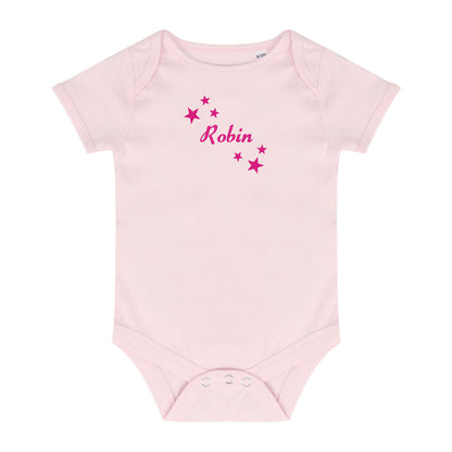 A light pink short-sleeve baby bodysuit with 'Robin' written in pink script font, surrounded by small pink stars on the chest, displayed on a solid white background.
