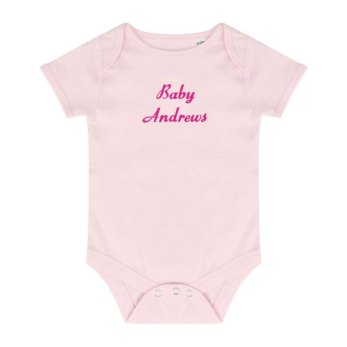A light pink short-sleeve baby bodysuit with 'Baby Andrews' embroidered in pink script across the chest, displayed on a solid white background.