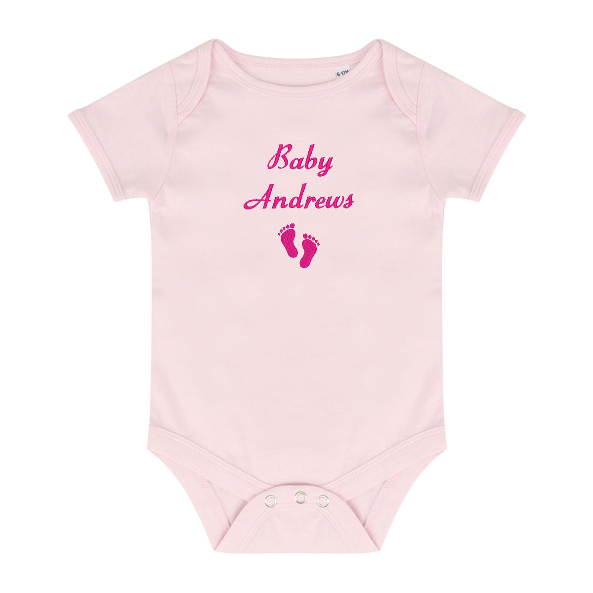 A light pink short-sleeve baby bodysuit with 'Baby Andrews' and baby footprints embroidered in pink on the chest, displayed on a solid white background.