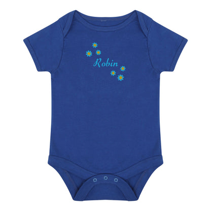 A royal blue short-sleeve baby bodysuit with three snap closures at the crotch and a personalized chest print featuring the name 'Robin' in light blue script surrounded by small yellow and blue flowers, shown on a plain white background.