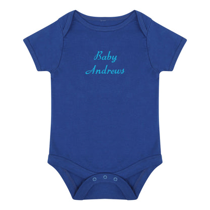 A royal blue short-sleeve baby bodysuit with 'Baby Andrews' embroidered in light blue cursive text on the chest, displayed on a solid white background.