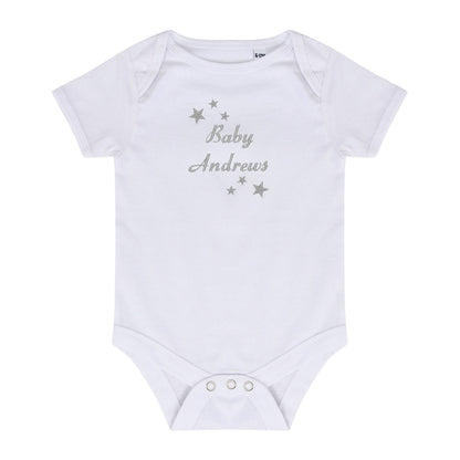 A white short-sleeve baby bodysuit with 'Baby Andrews' and silver stars embroidered on the chest, displayed flat against a white background.