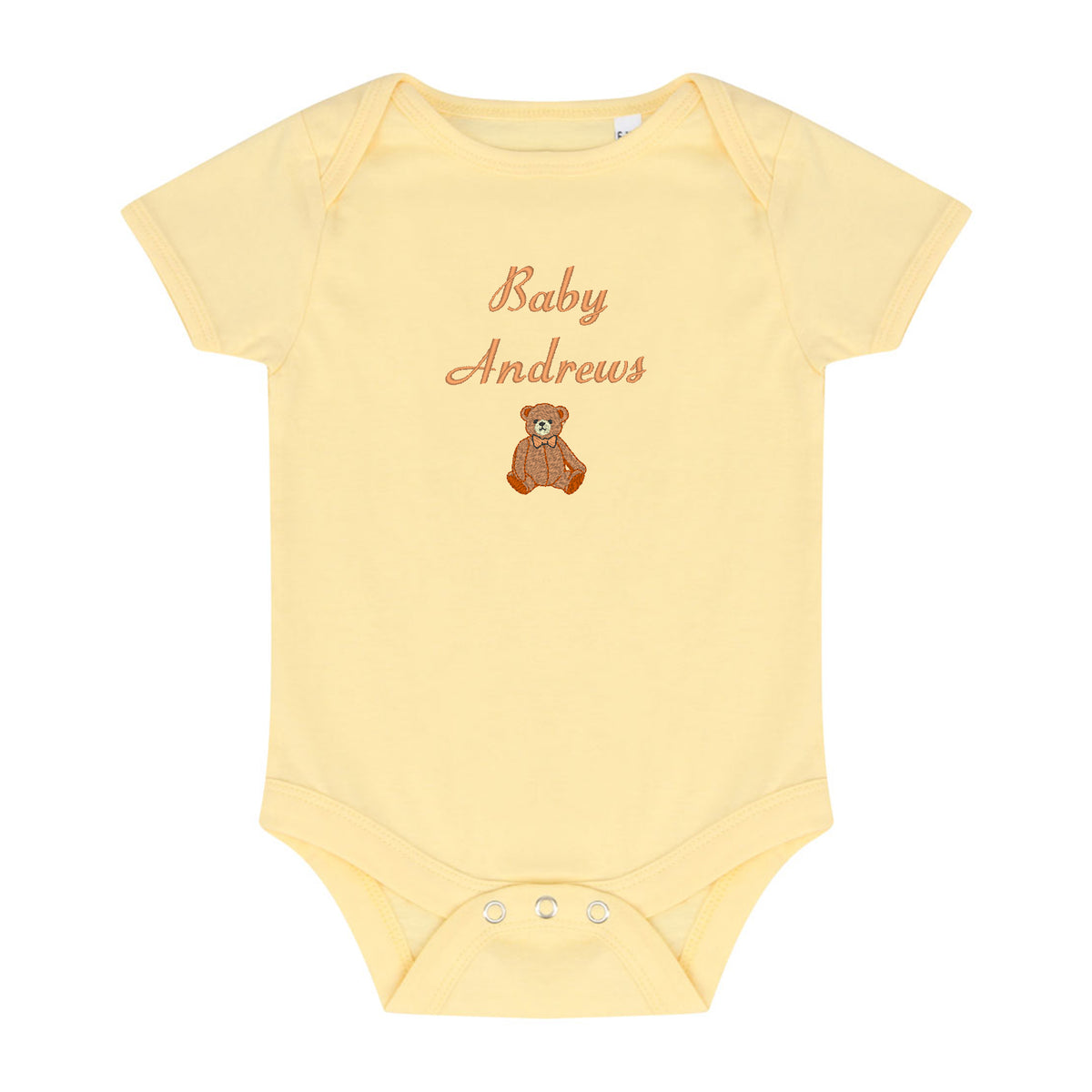 A pale yellow short-sleeve baby bodysuit with 'Baby Andrews' embroidered in a brown cursive font above a small brown teddy bear graphic, shown on a plain white background.