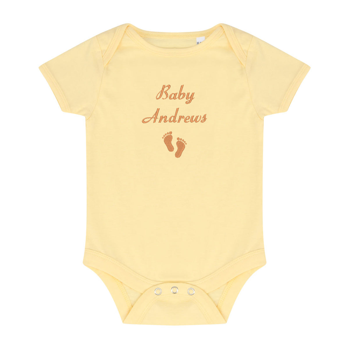 A pale yellow short-sleeve baby bodysuit with 'Baby Andrews' and baby footprints embroidered in brown on the chest, shown on a plain white background.